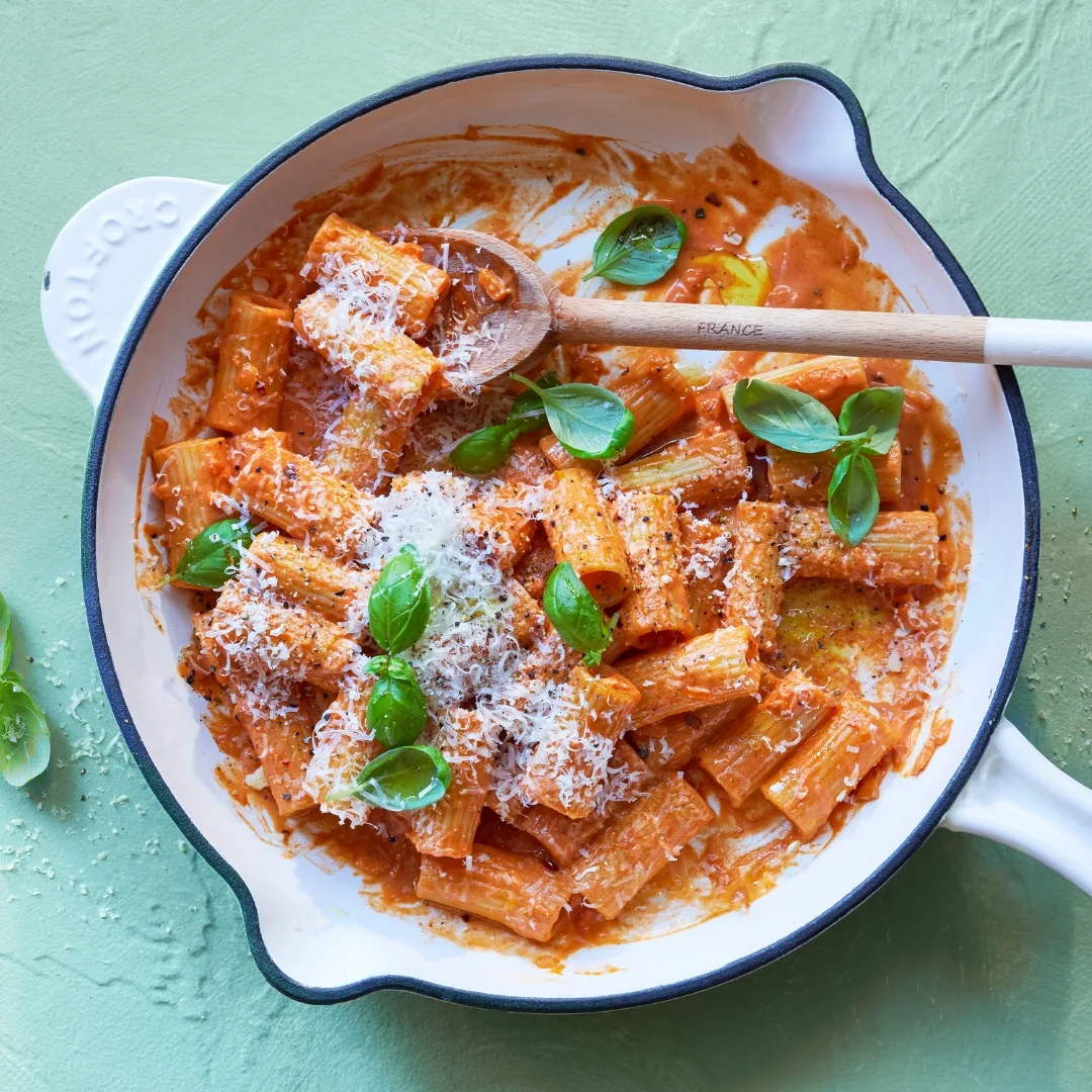 Pasta alla vodka in a frying pan with a spoon
