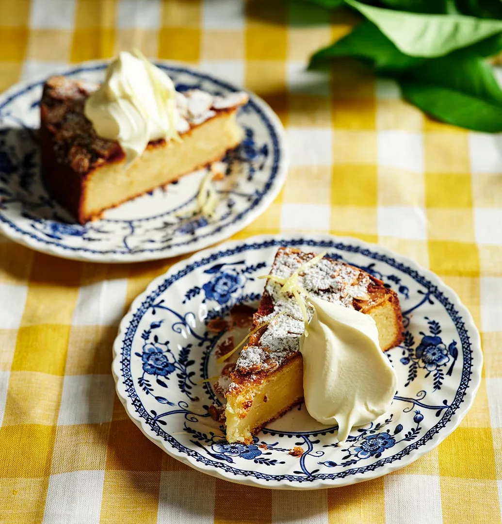 Two slices of lemon ricotta cake on plates