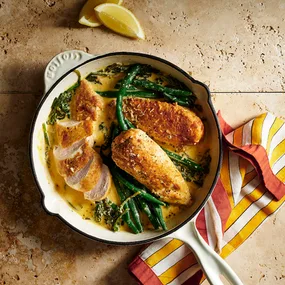Creamy lemon chicken in a white frying pan