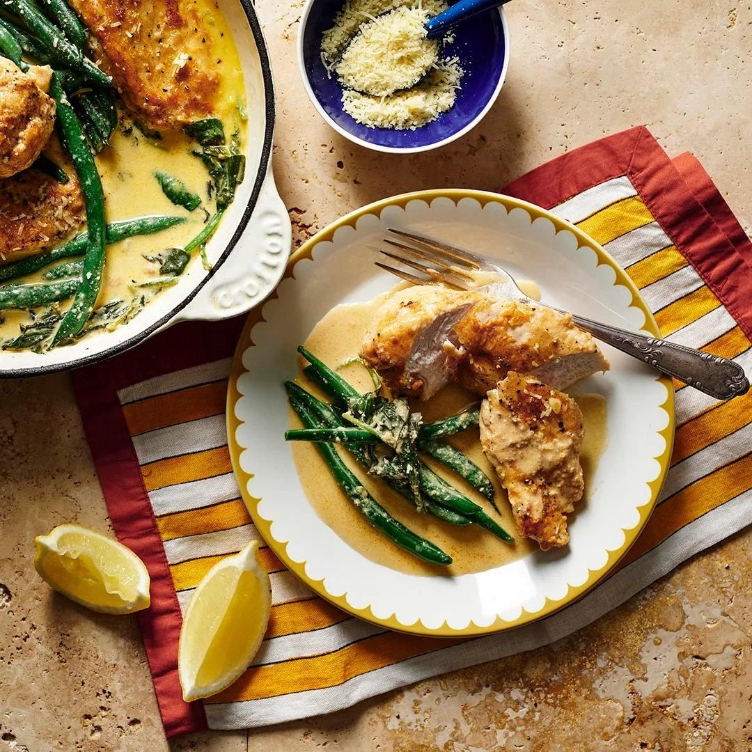 Serve of creamy lemon chicken with lemon and parmesan on the side
