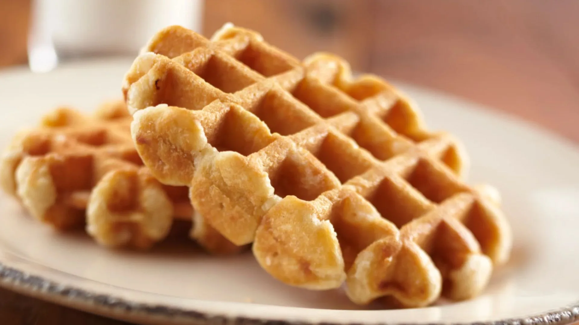 Plain Belgian waffles on a plate with a blurred background