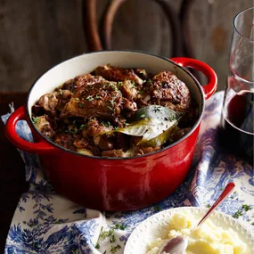 Julie Goodwin's coq au vin in a casserole dish, with mashed potato on the side