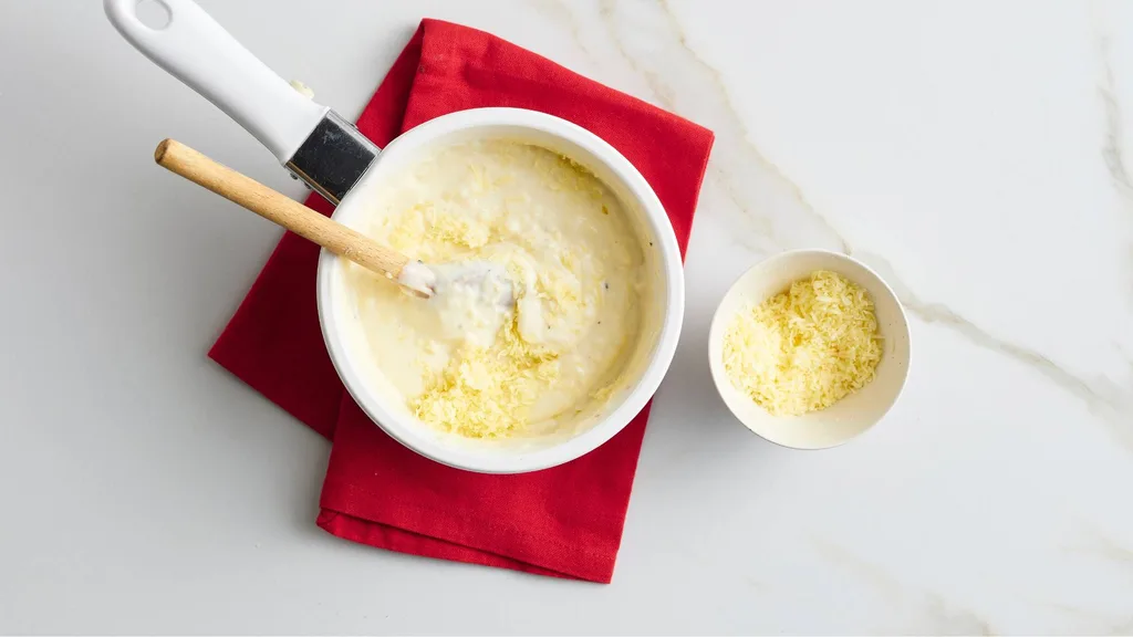 Making cheesy bechamel sauce