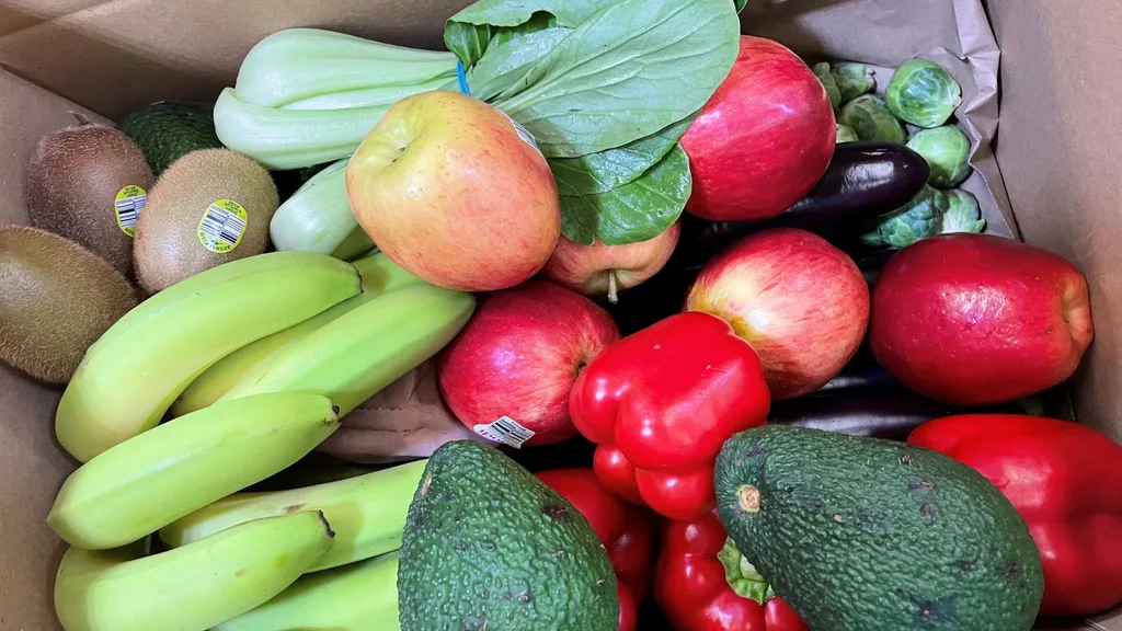 A cardboard box filled with fresh produce from Farmers Pick.