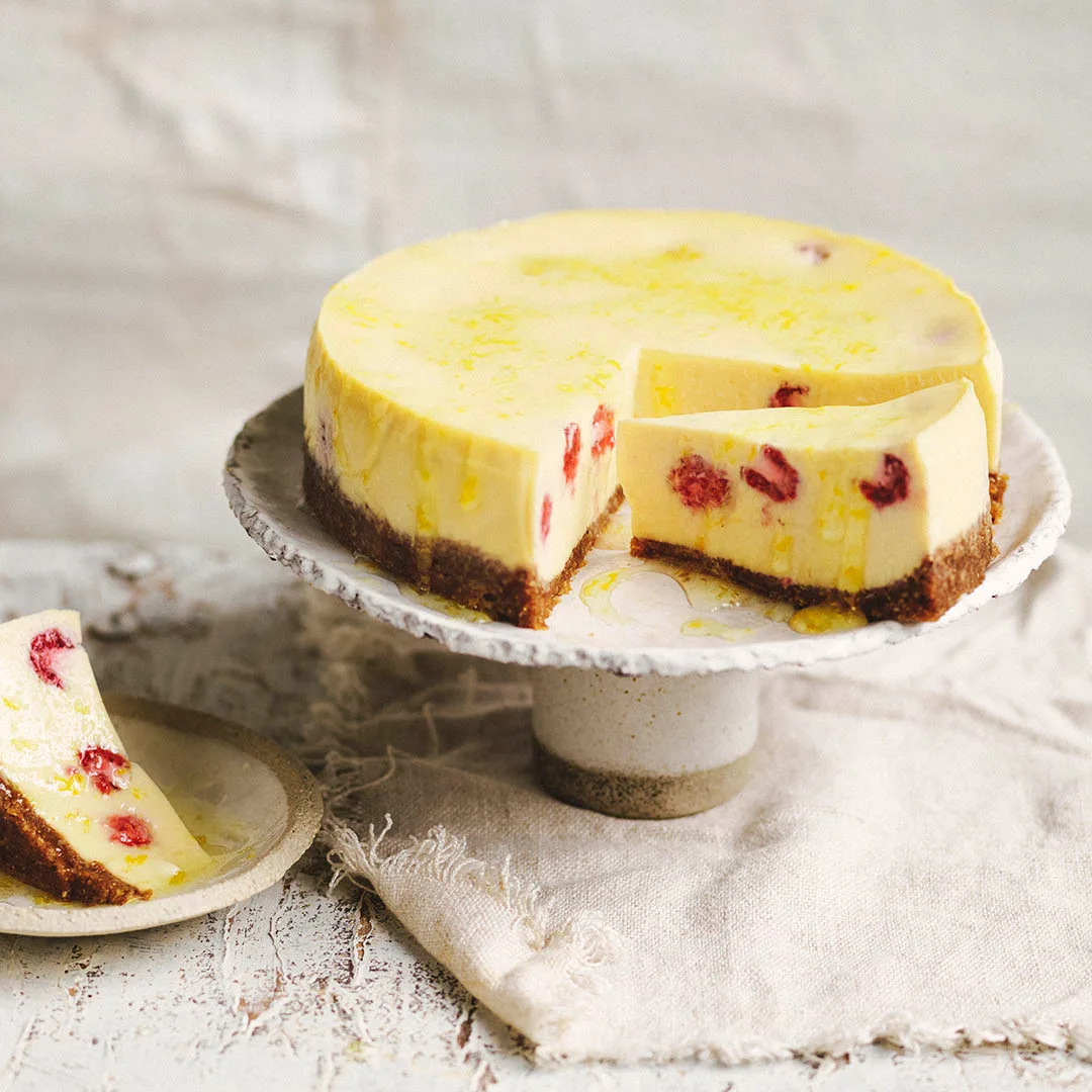 raspberry baked cheesecake on a cake stand