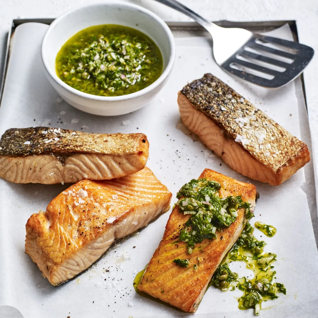 air fryer salmon with crispy skin and topped with salsa verde