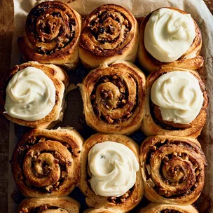apple & cinnamon scrolls on a tray, some iced and some uniced