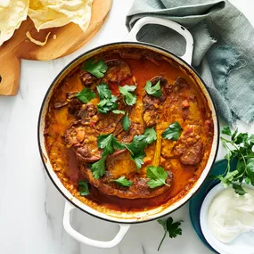 Julie Goodwin's braised lamb chops in a white pan sprinkled with parsley