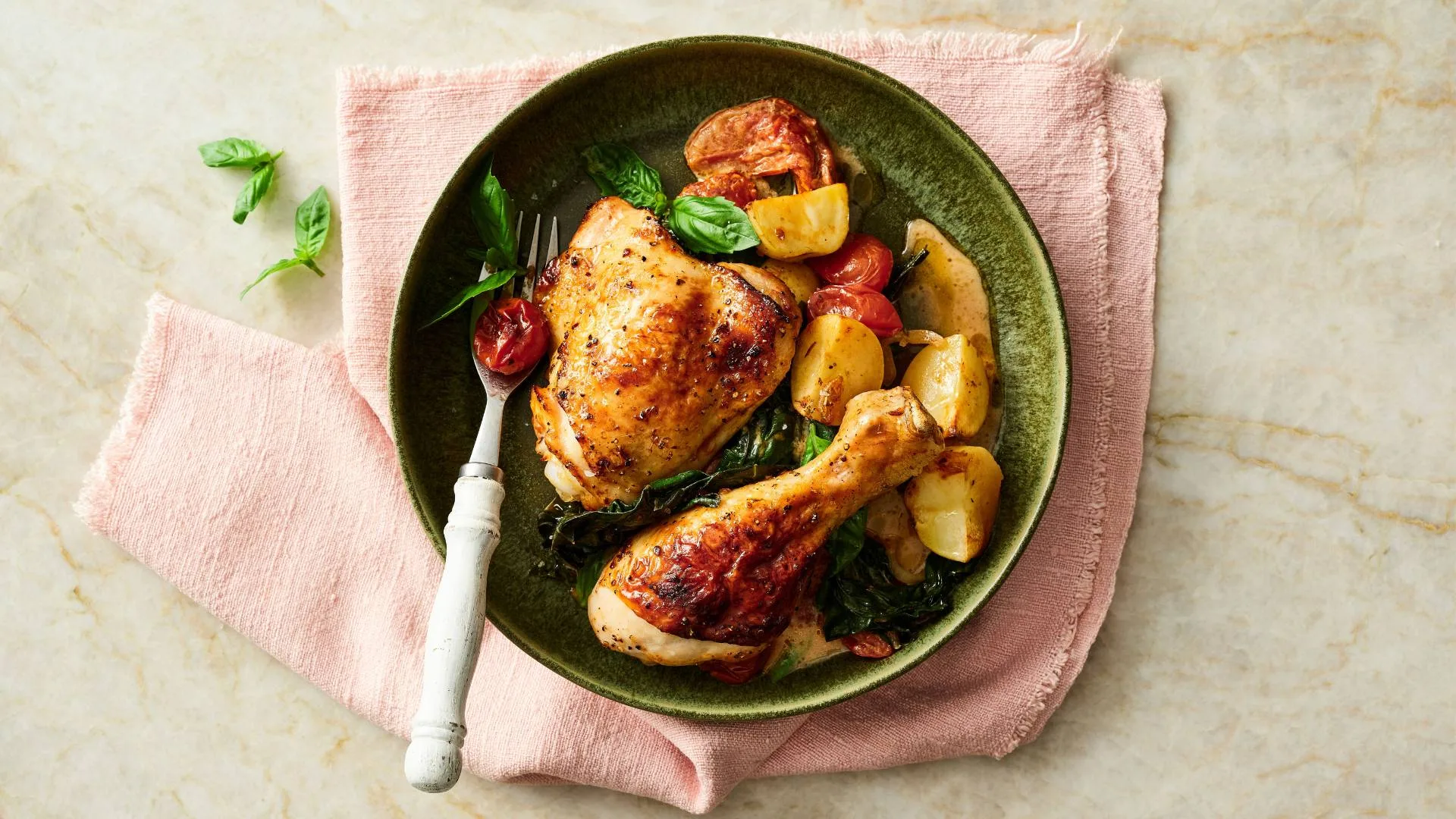 Tuscan chicken tray bake served on a dinner plate