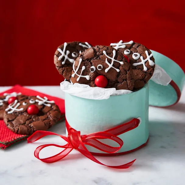 A rudolph brookie batch in a green biscuit tin wrapped with red ribbon