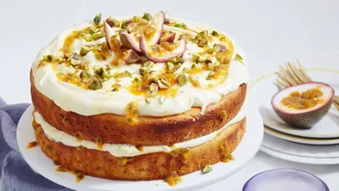 Vanilla yoghurt and passionfruit cake on a white cake stand. vanilla dessert recipe