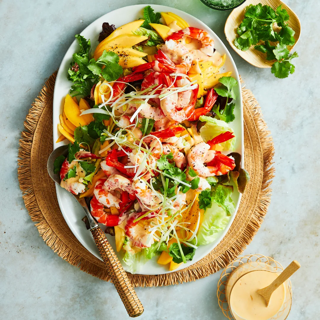 Prawn and mango salad on a white plate