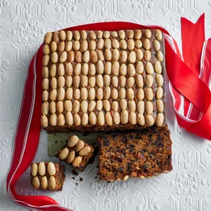easy melt and mix fruit cake with almonds on top, and red ribbon