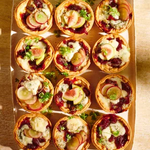 Twelve individual Maggie Beer blue cheese tarts on a serving platter