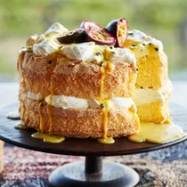 Maggie Beer’s passionfruit curd sponge cake on a dark cake stand