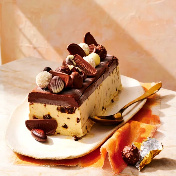Ice cream Christmas cake loaf topped with chocolates on a platter