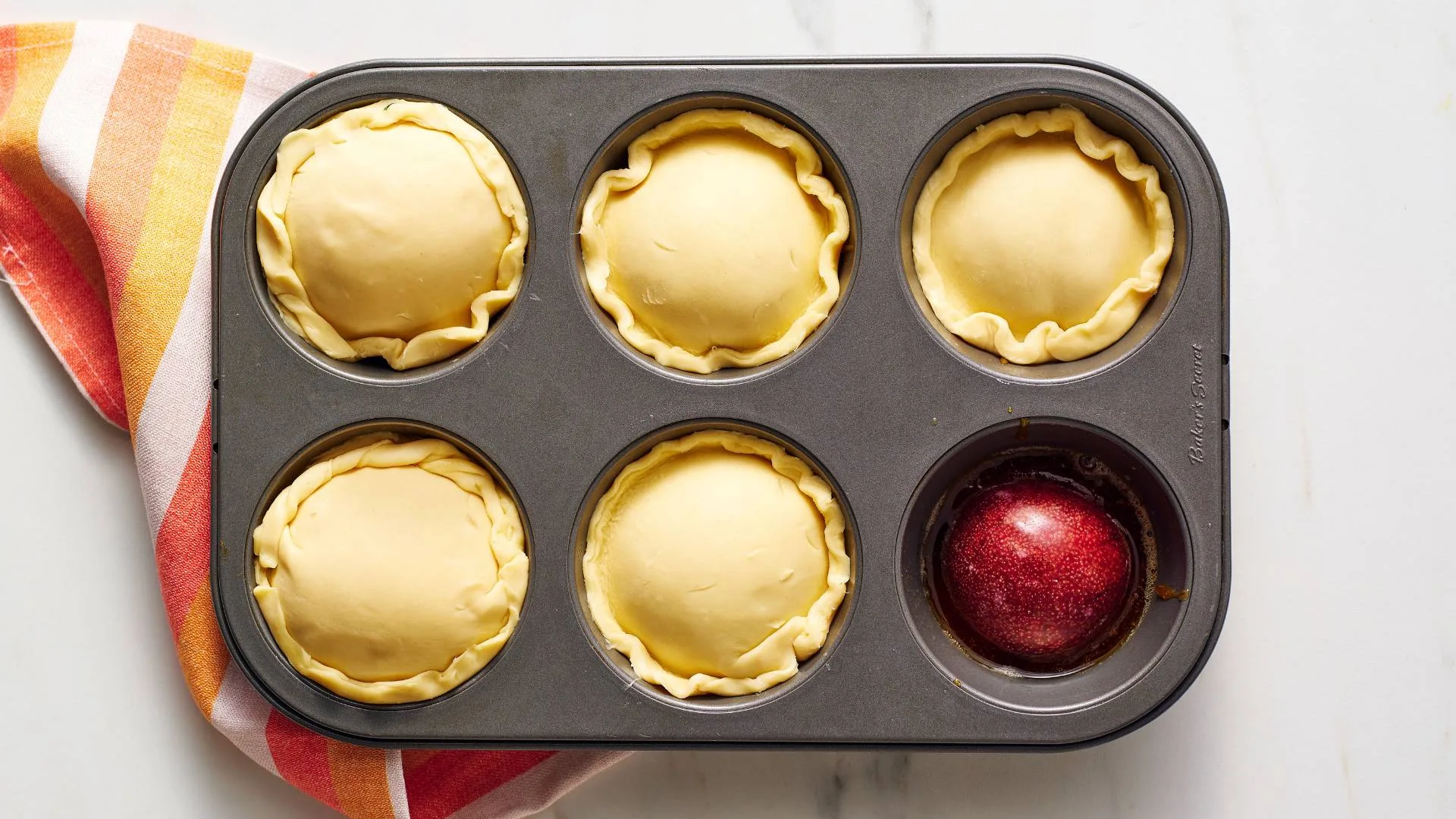 Position pastry circles on top of fruit. Using a butter knife, tuck the edges of the pastry around the fruit