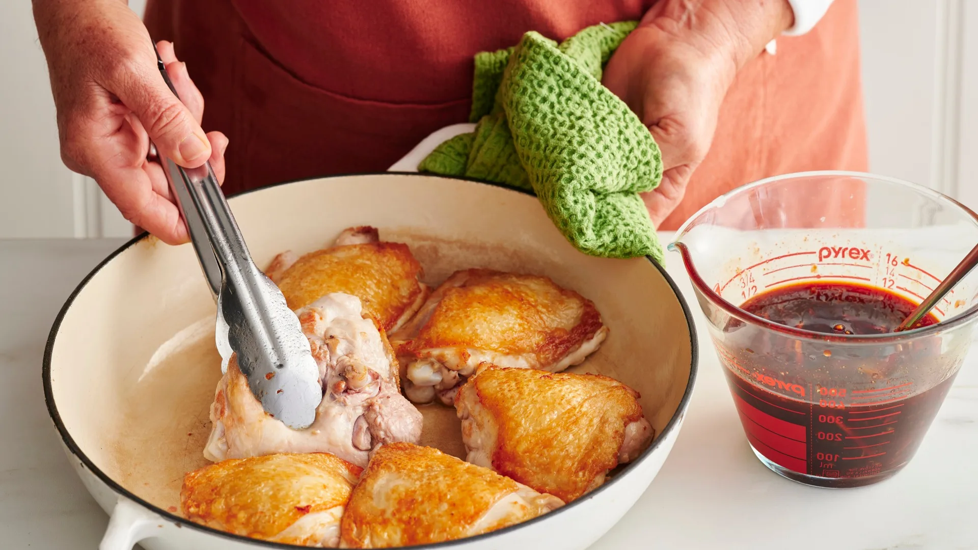 char siu chicken by Julie Goodwin step photo of turning a chicken thigh cutlet in a pan