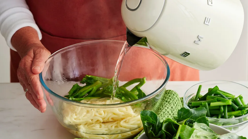 char siu chicken by Julie Goodwin step photo of pouring boiling water into a bowl of noodles