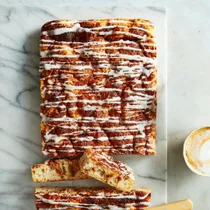 cinnamon sweet focaccia with a vanilla icing drizzled over top