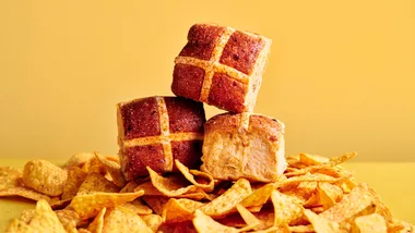Doritos Hot Cross Buns on a pile of doritos chips in front of a yellow background