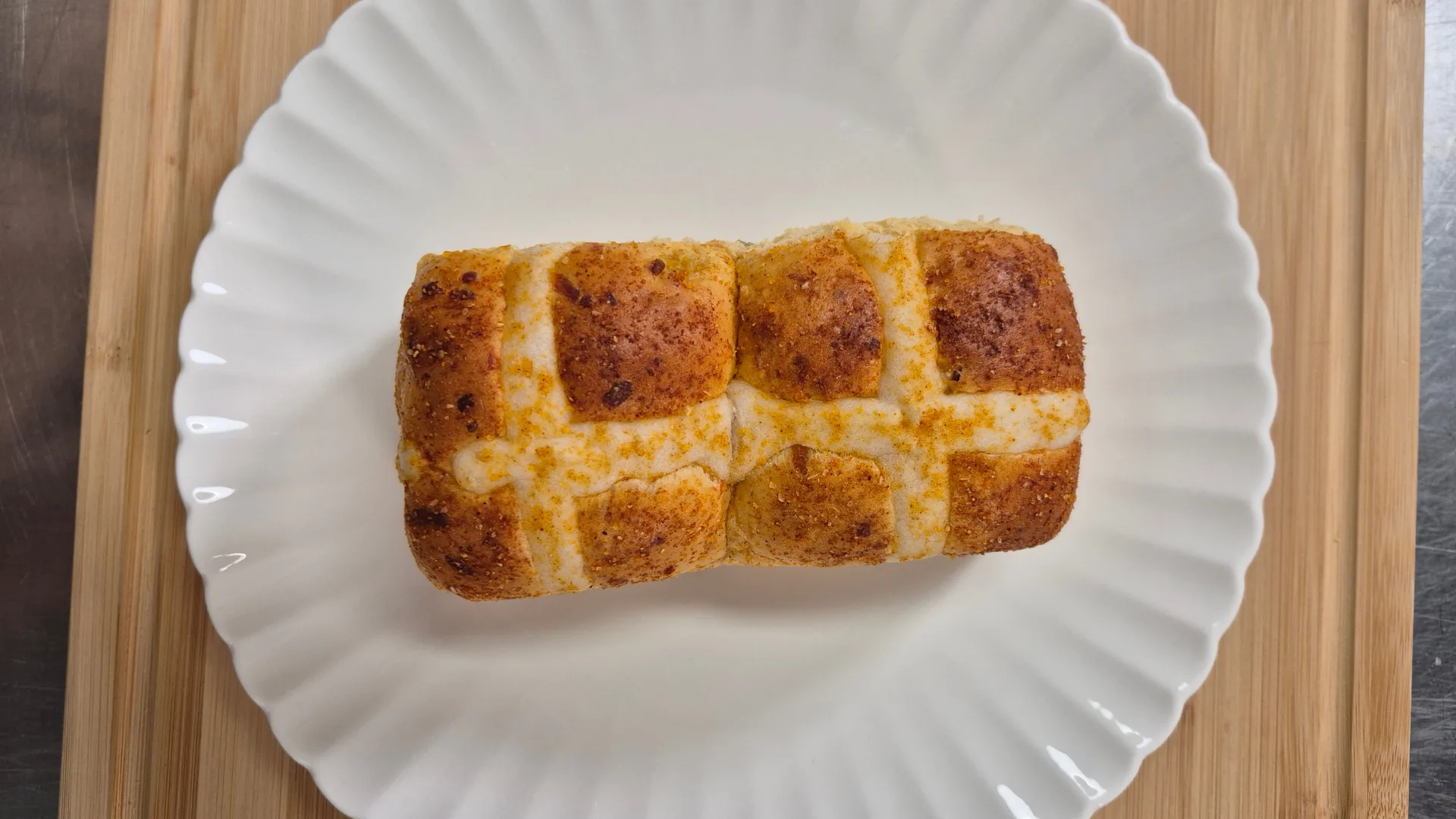 two doritos hot cross buns on a white plate
