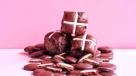 Mint Slice hot cross buns on a pile of Arnott's mint slice biscuits