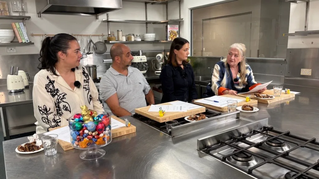 four people sit in the women's weekly test kitchen