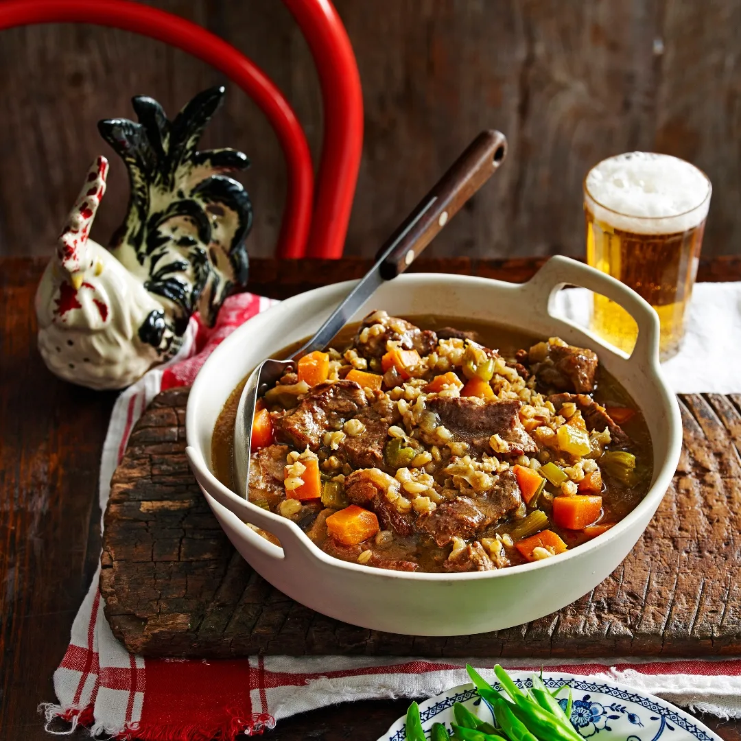 julie goodwin's slow cooked beef stew in a white serving dish on a table