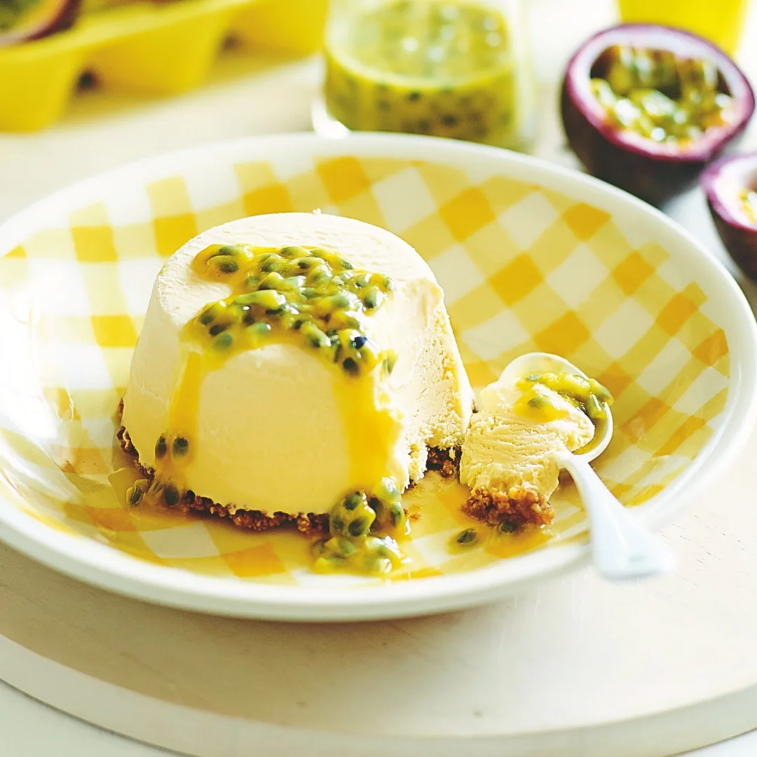 julie goodwin mini cheesecakes on a yellow and white plate, topped with passionfruit