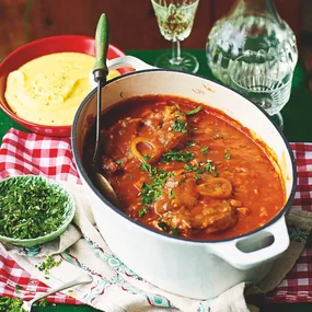 julie goodwin's osso buco in a white serving dish with a bowl of polenta