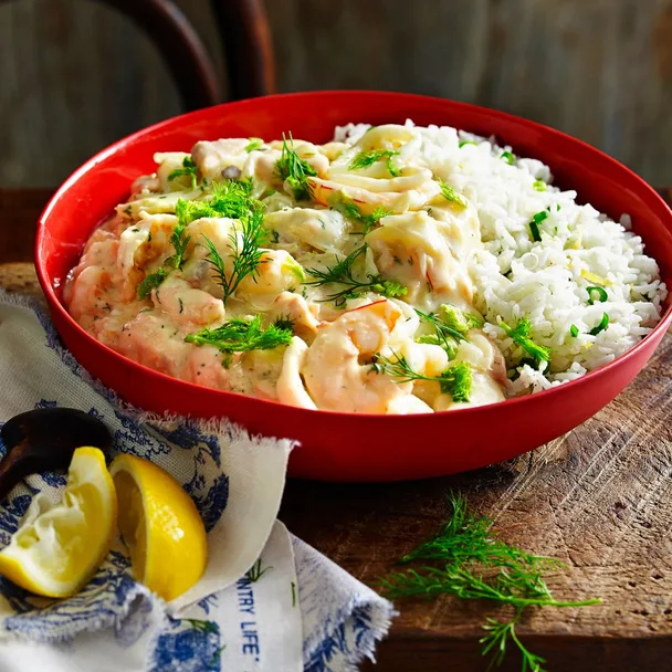 seafood mornay by julie goodwin in a red bowl with lemon wedges