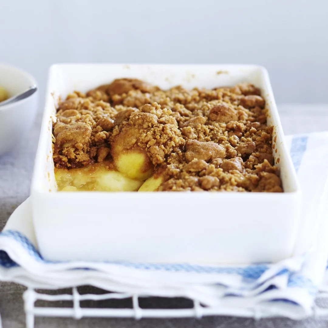 Apple crumble in white baking dish
