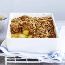 Apple crumble in white baking dish
