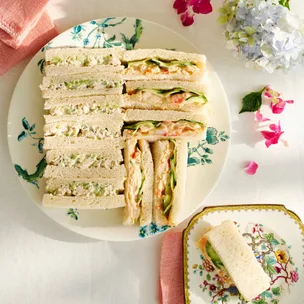 two varieties of high tea sandwiches on floral plates