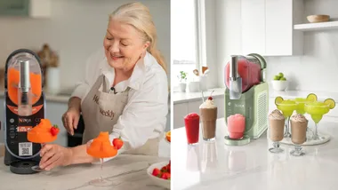A side-by-side image showing the Ninja Slushi in action. On the left, Fran from Women’s Weekly Food smiles while serving a bright orange frozen drink from a black Ninja Slushi. On the right, the new sage green "Margarita" Ninja Slushi is displayed on a white marble benchtop surrounded by various frozen cocktails, including frappes and margaritas.