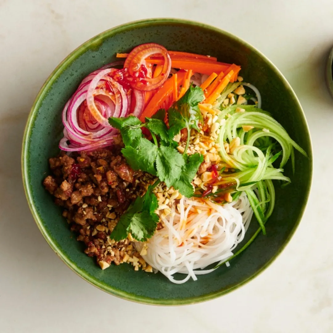 vietnamese minced pork noodles in a green bowl