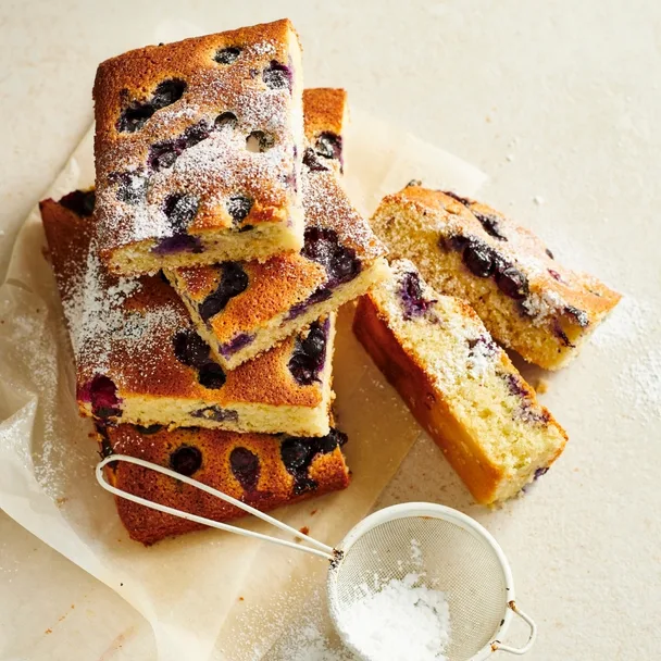 Blueberry friand slice, cut into large pieces and dusted with icing sugar