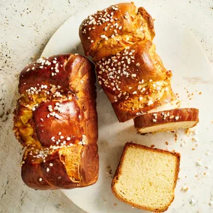 Two brioche loaves, one with a couple of slices removed