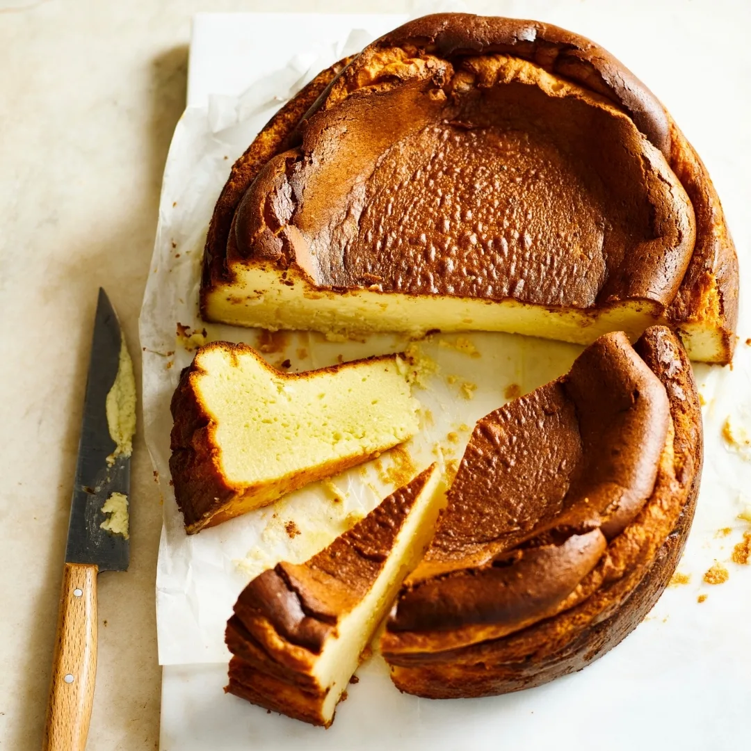 Burnt Basque cheesecake cut in half, with two slices separated