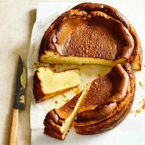 Burnt Basque cheesecake cut in half, with two slices separated
