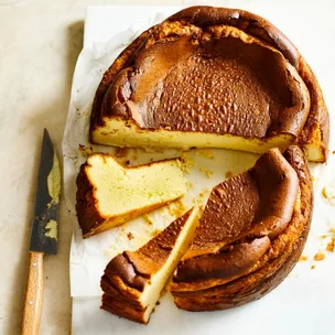 Burnt Basque cheesecake cut in half, with two slices separated