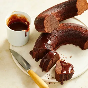 chocolate ring cake cut in half drizzled with icing