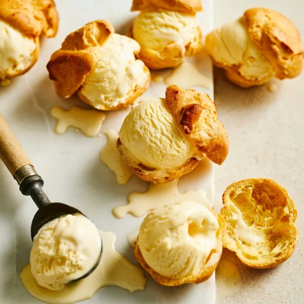 Choux pastries, cut in half with ice-cream in the middle.