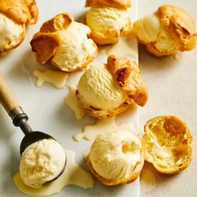 Choux pastries, cut in half with ice-cream in the middle.