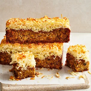 cake cut in half with a coconut topping