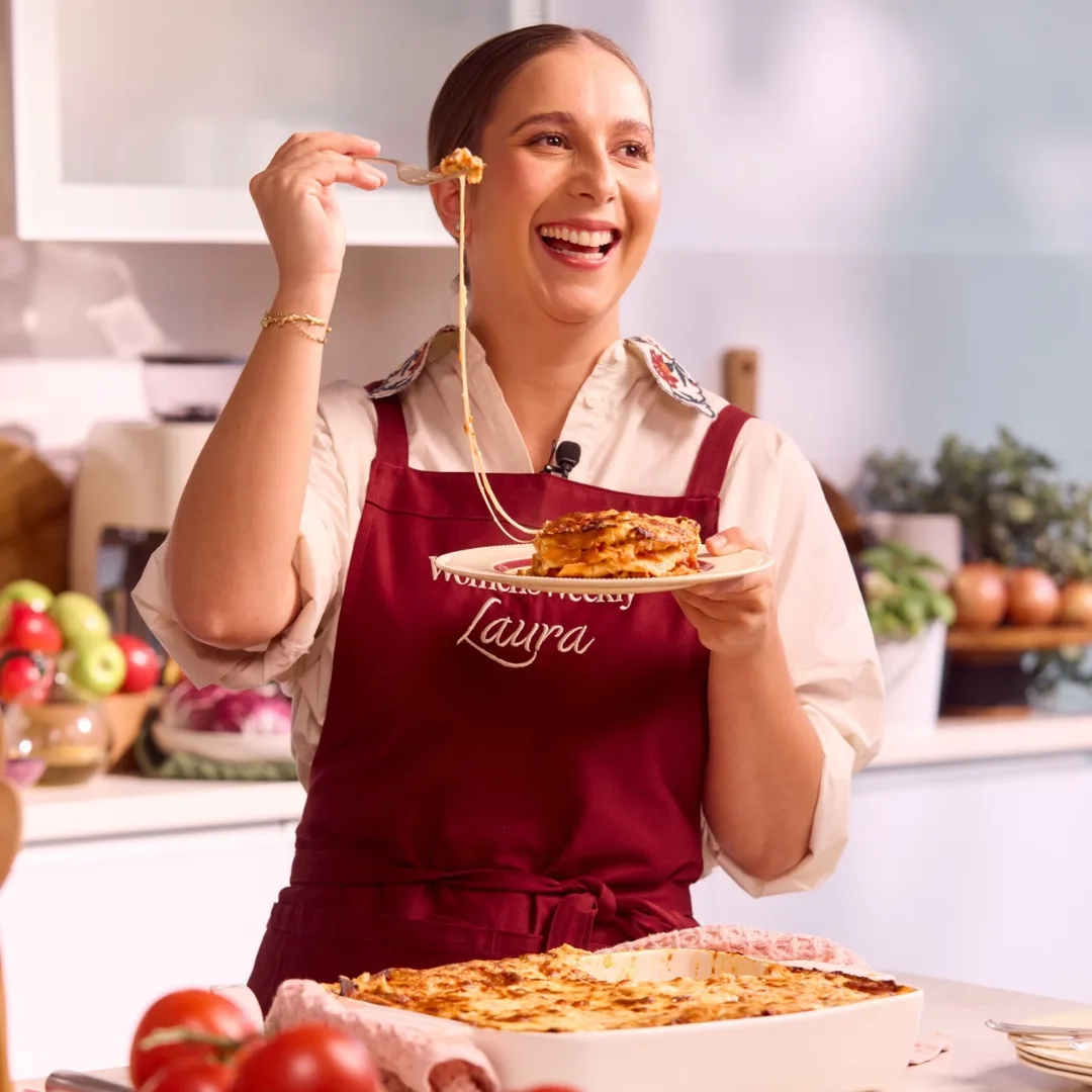 laura sharrad holding a plate of lasagne