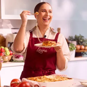 laura sharrad holding a plate of lasagne