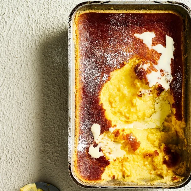 lemon and coconut delicious pudding drizzled with cream