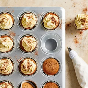 Malted milk cupcakes in a baking pan with buttercream frosting